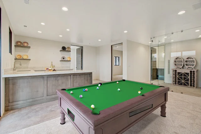 Basement recreation room with pool table and wet bar
