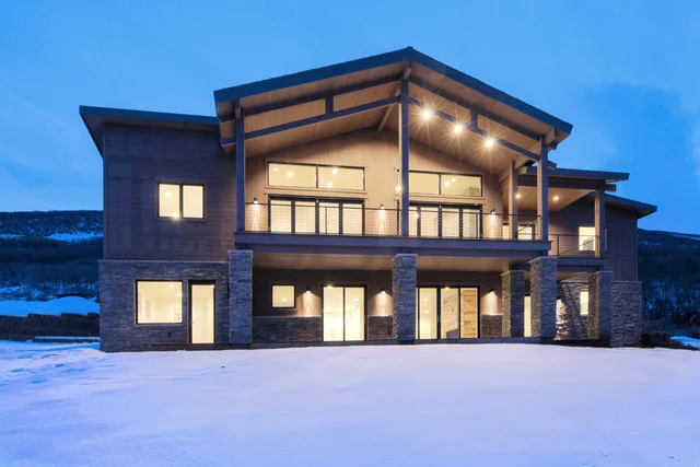 Rear view of Deer Mountain custom home with upper deck, Park City
