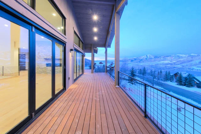 Covered deck with wood decking and mountain views in Deer Mountain custom home, Park City