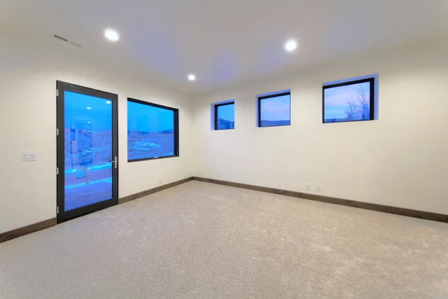 Lower level basement bedroom with patio door in Deer Mountain custom home, Park City