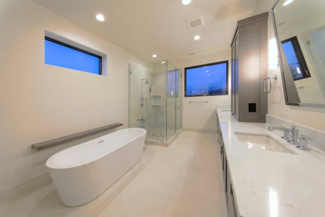 Master bath with freestanding tub, glass shower, and vanity in Deer Mountain custom home, Park City