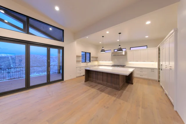 Kitchen with white cabinets and dark island