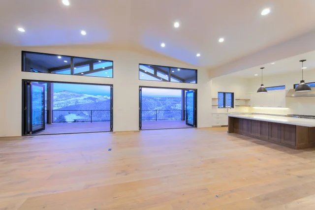 Great room wide view with two slider openings in Deer Mountain custom home, Park City