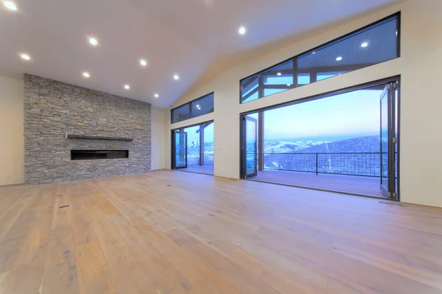 Great room with folding glass doors in Deer Mountain custom home, Park City