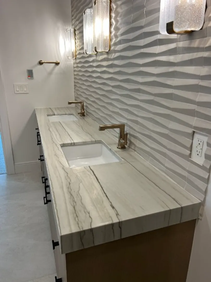 Marble dual vanity with wave tile backsplash and gold fixtures in Deer Valley