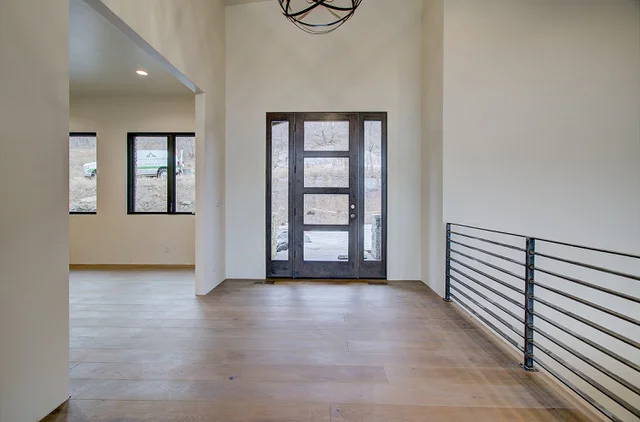 Entry foyer with tall ceiling and chandelier
