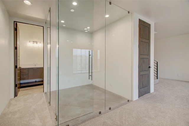 Glass-enclosed steam room with bedroom doorway in Slalom Run luxury home