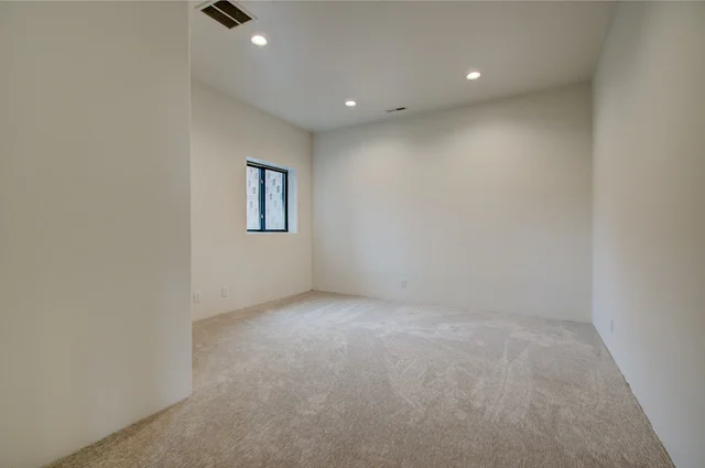 Lower level carpeted room with small window in Slalom Run home