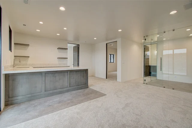 Basement wet bar area with glass steam and sauna room in Park City custom home