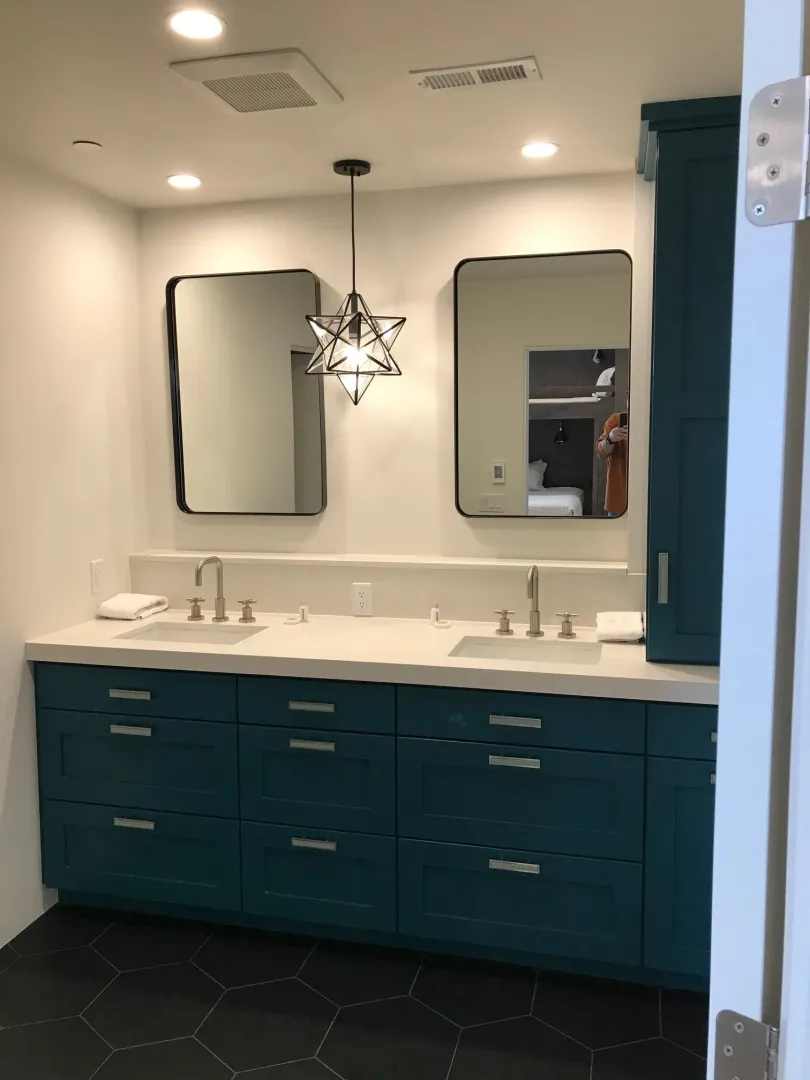 Teal vanity bathroom with hex tile