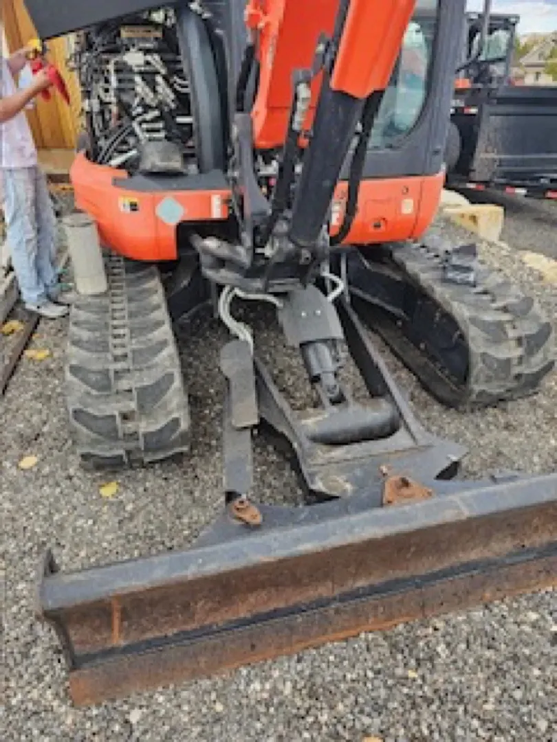 Kubota excavator with blade attachment for grading and site preparation