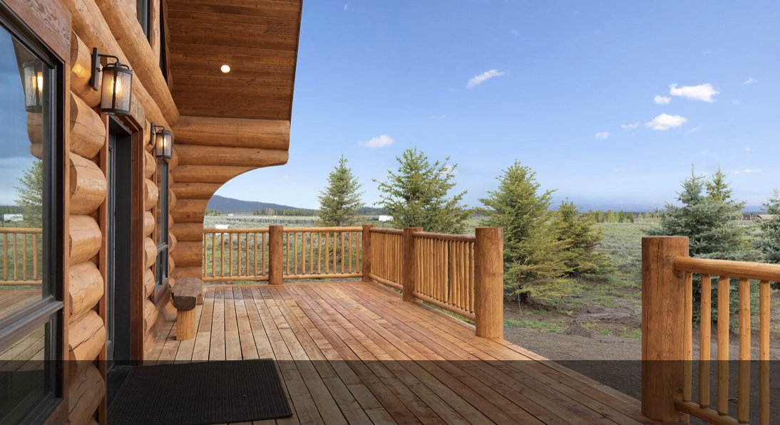 Finished log home deck and mountain setting