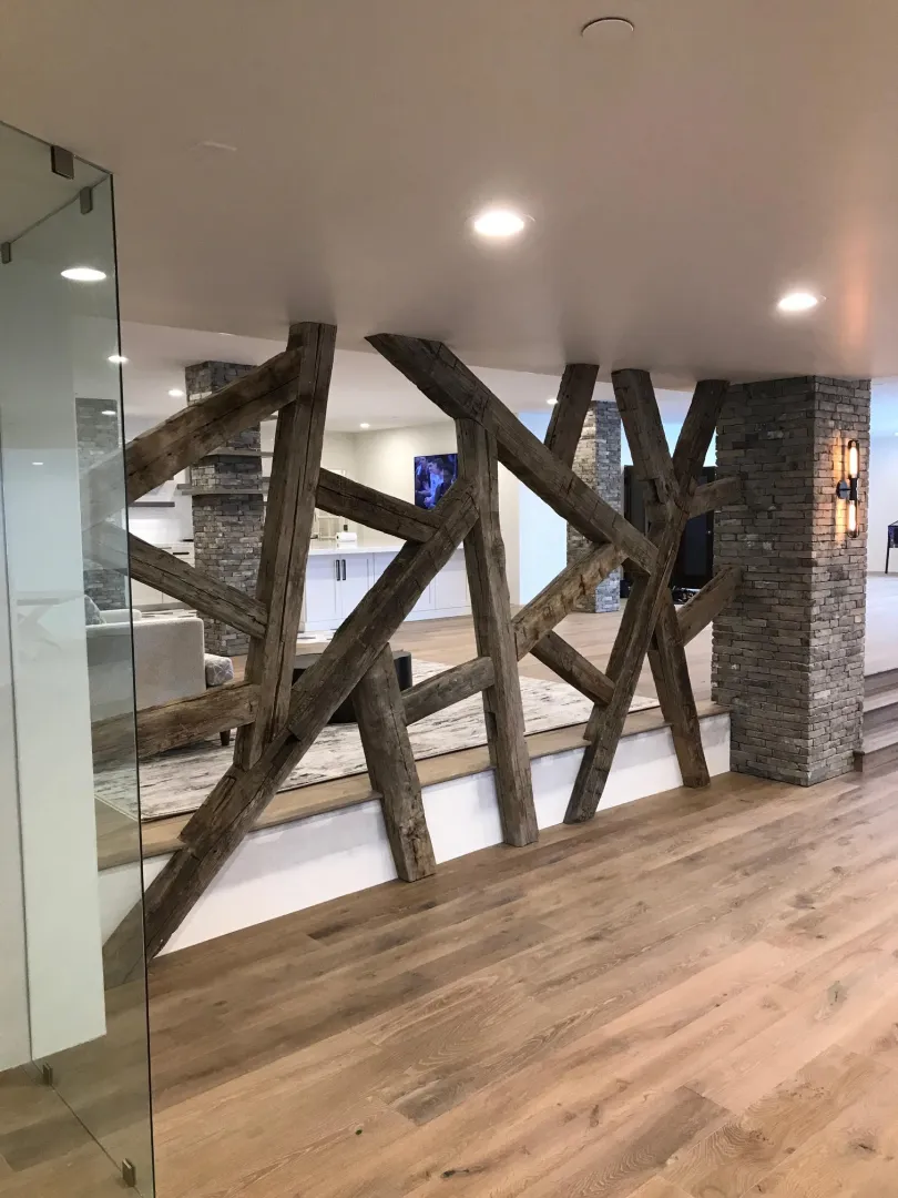 Finished basement with rustic timber beams and custom stonework in Park City Utah