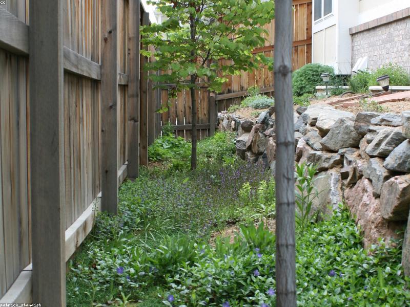Natural boulder retaining wall in garden landscape